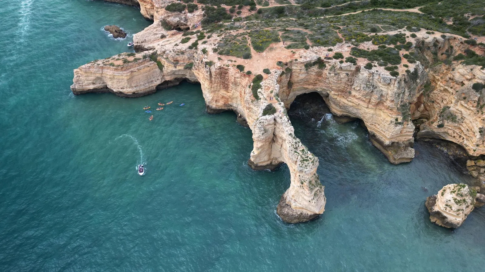 Aerial view of limestone cliffs and turquoise sea on the Algarve coast
